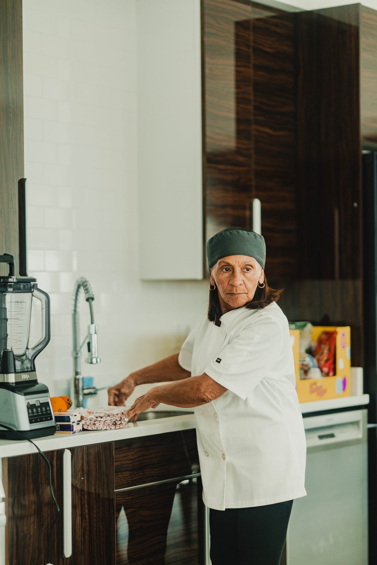 Chef preparing food in a sunlit kitchen